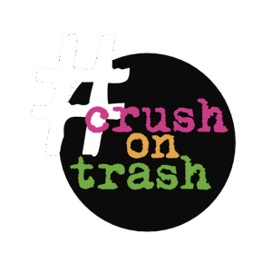 Duży biały hashtag nakłada się na czarny okrąg zawierający słowa crush on trash z teksturowanymi różowymi, pomarańczowymi i zielonymi literami, oddając ducha sztuki i kreatywności widocznego w projektach takich jak Przestrzenie Sztuki i ich Partnerzy.